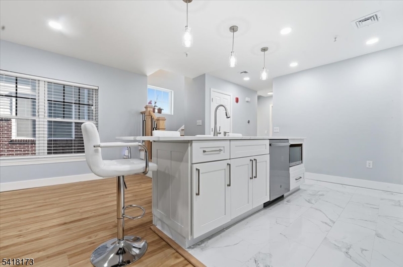 181 Court Street Newark, NJ 07103 - Photo 12 of 38 a kitchen with a sink a table and chairs