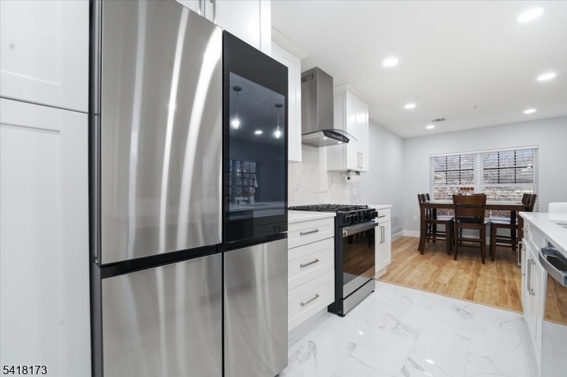 181 Court Street Newark, NJ 07103 - Photo 14 of 38 a kitchen with stainless steel appliances granite countertop a refrigerator and a stove top oven