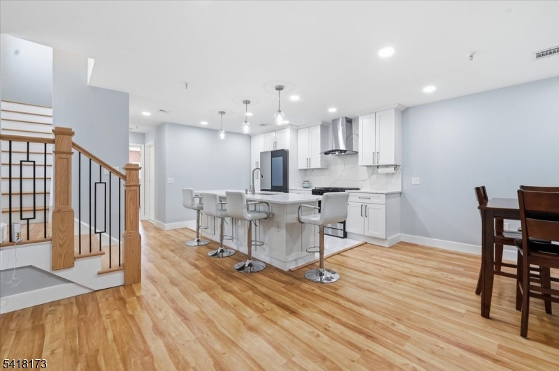 181 Court Street Newark, NJ 07103 - Photo 15 of 38 a view of kitchen with cabinets and wooden floor