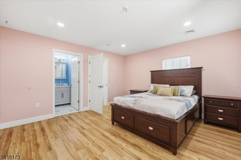 181 Court Street Newark, NJ 07103 - Photo 19 of 38 a spacious bedroom with a bed and a dresser
