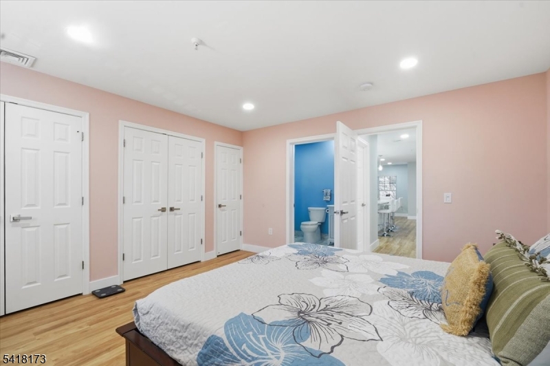 181 Court Street Newark, NJ 07103 - Photo 20 of 38 a bedroom with a bed and a mirror