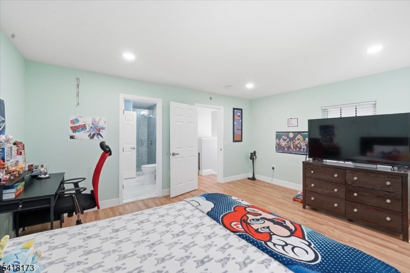 181 Court Street Newark, NJ 07103 - Photo 22 of 38 a bedroom with a bed and a flat screen tv