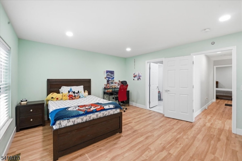 181 Court Street Newark, NJ 07103 - Photo 23 of 38 a bedroom with a bed and wooden floor