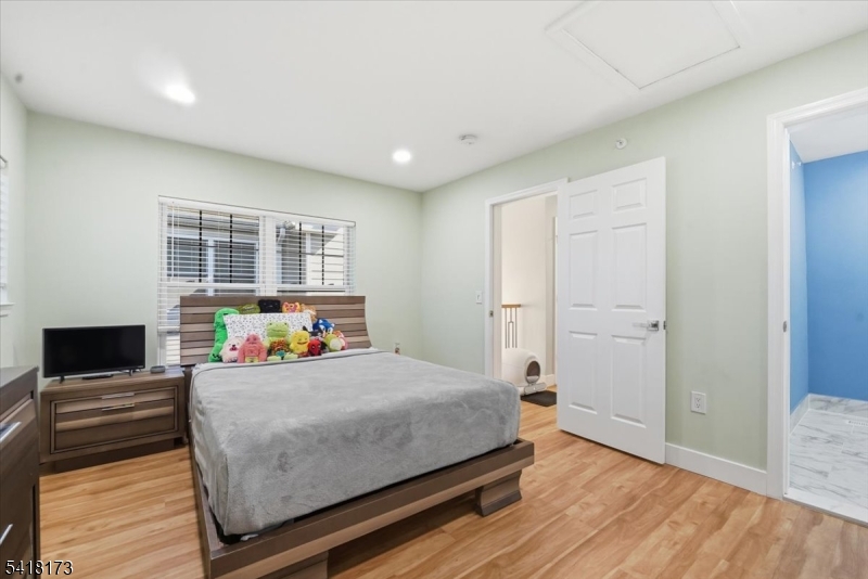 181 Court Street Newark, NJ 07103 - Photo 26 of 38 a bedroom with a bed and a flat screen tv