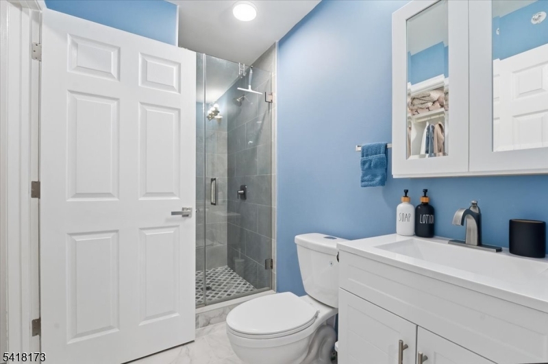 181 Court Street Newark, NJ 07103 - Photo 31 of 38 a bathroom with a toilet a sink and shower