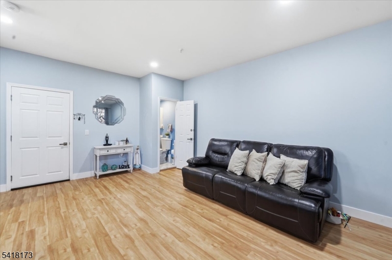 181 Court Street Newark, NJ 07103 - Photo 4 of 38 a living room with furniture and a wooden floor