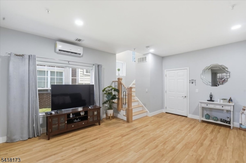 181 Court Street Newark, NJ 07103 - Photo 7 of 38 a living room with furniture and a flat screen tv