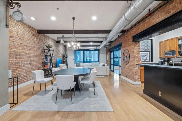 a dining room with furniture and wooden floor