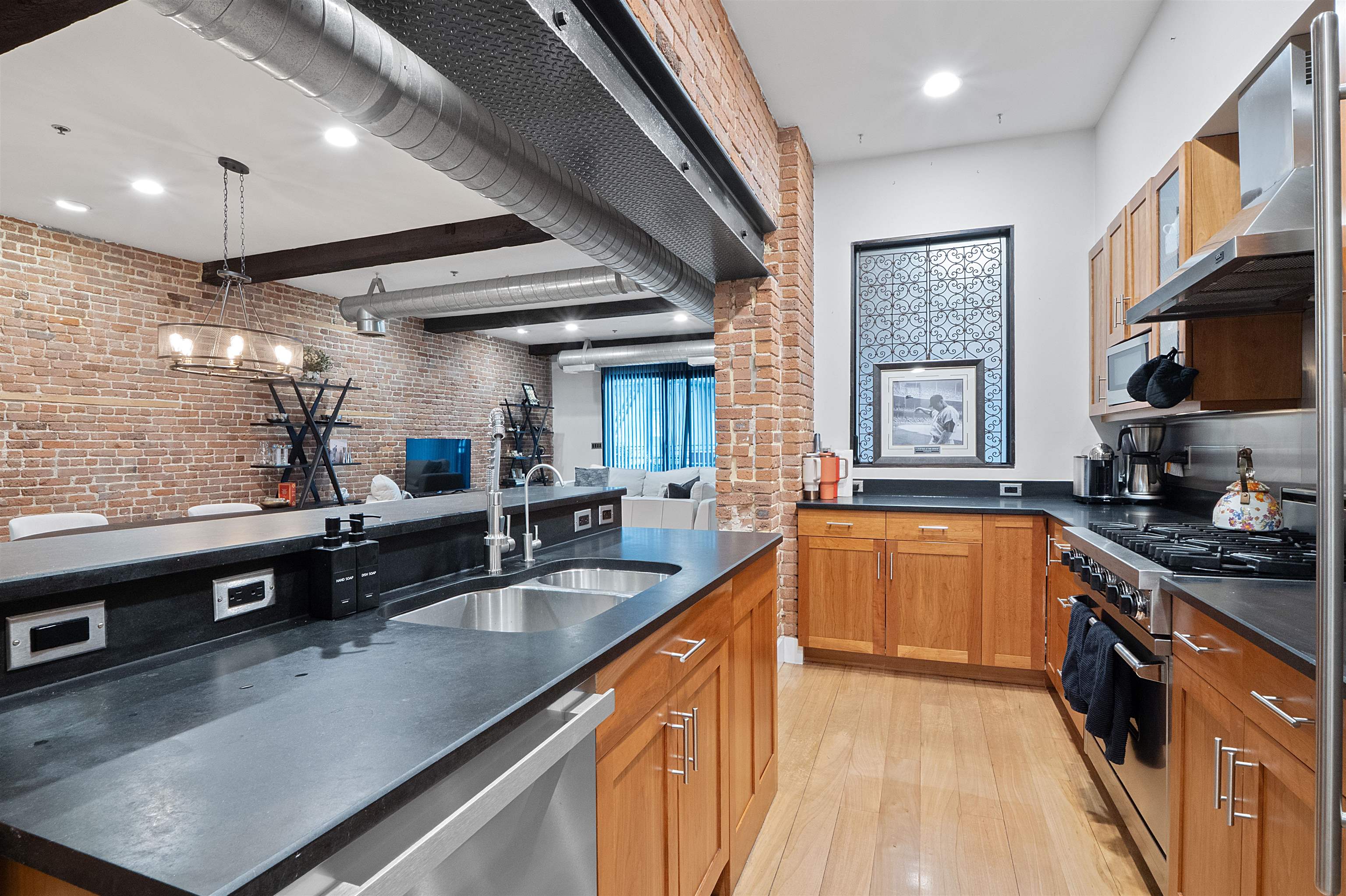 610 Clinton Street, Unit 2A Hoboken, NJ 07030 - Photo 17 of 33 a kitchen with stainless steel appliances granite countertop a sink a stove top oven a counter space and cabinets