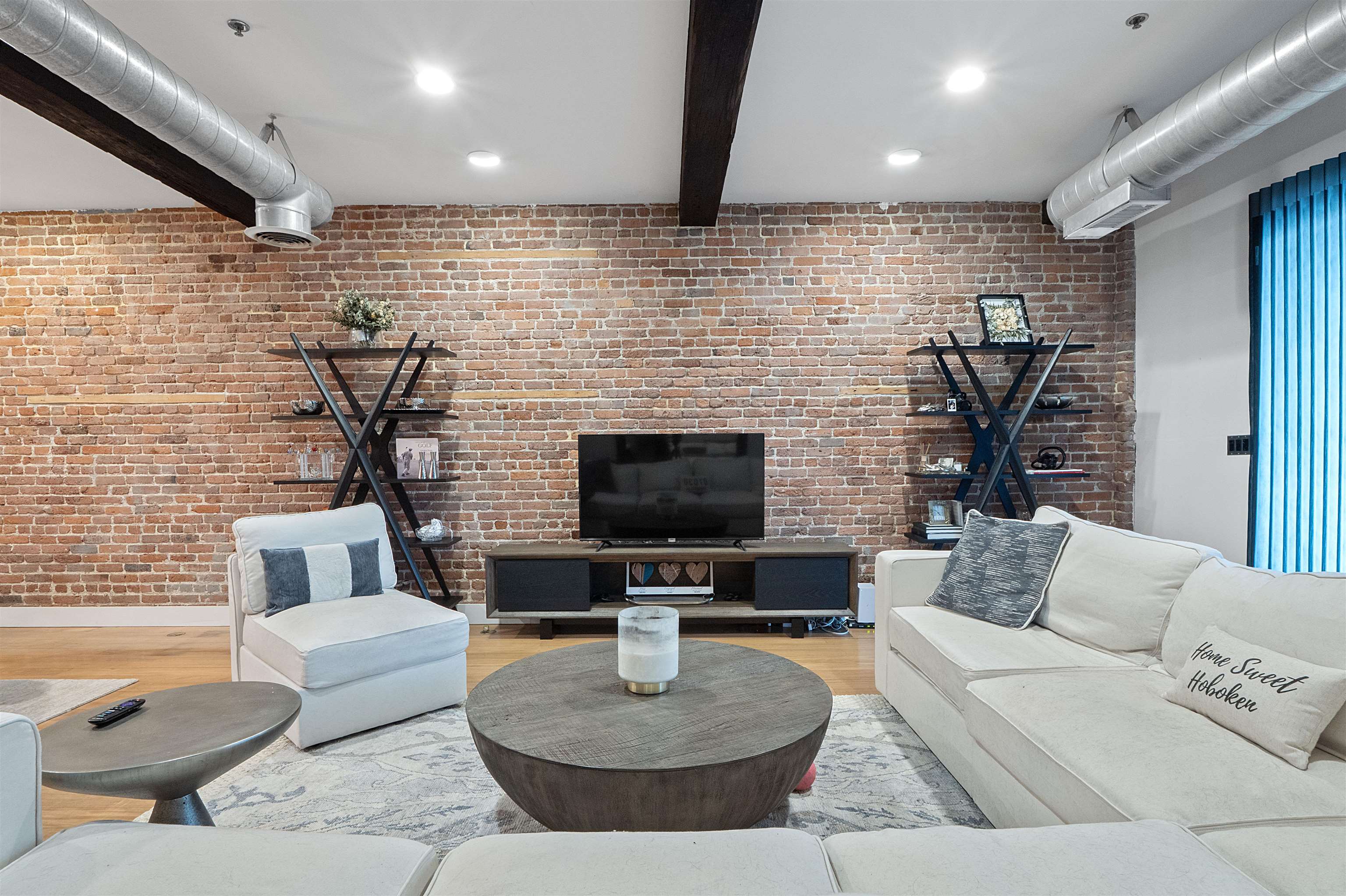 610 Clinton Street, Unit 2A Hoboken, NJ 07030 - Photo 20 of 33 a living room with furniture and a flat screen tv