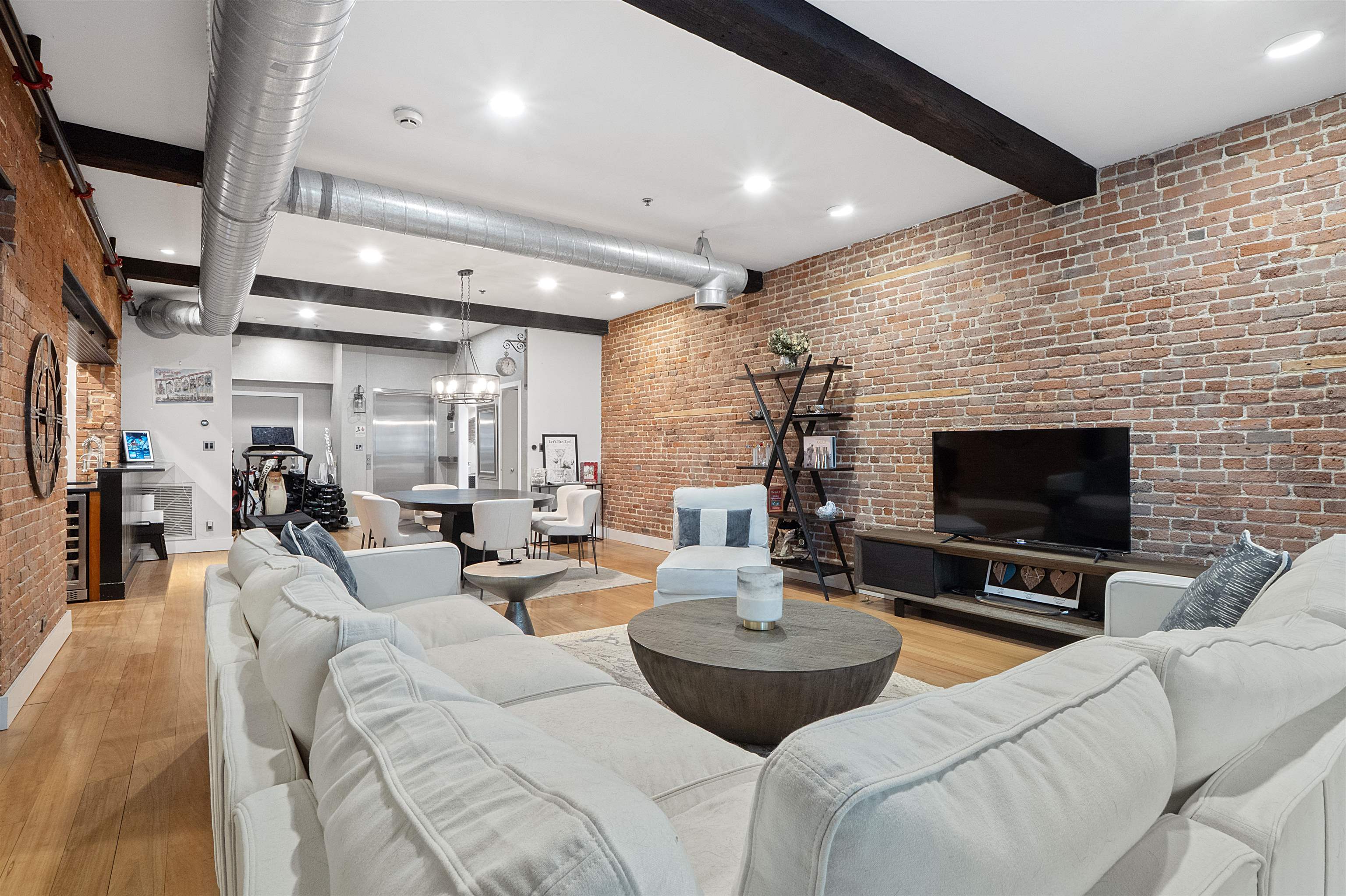610 Clinton Street, Unit 2A Hoboken, NJ 07030 - Photo 21 of 33 a living room with furniture and a flat screen tv