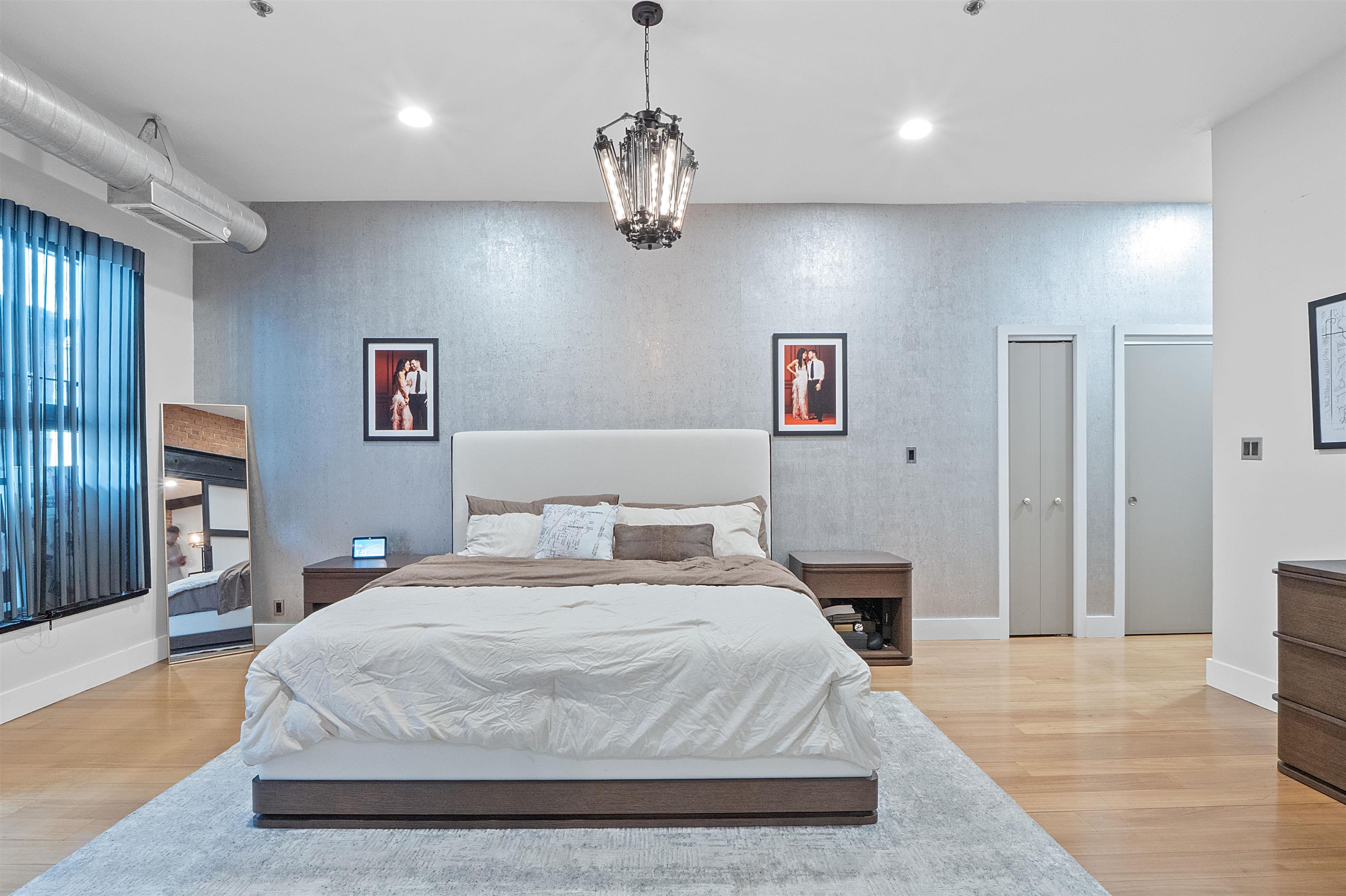 610 Clinton Street, Unit 2A Hoboken, NJ 07030 - Photo 24 of 33 a bedroom with a large bed and wooden floor