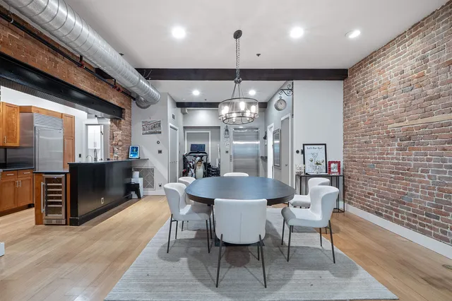 a dining room with furniture and a chandelier
