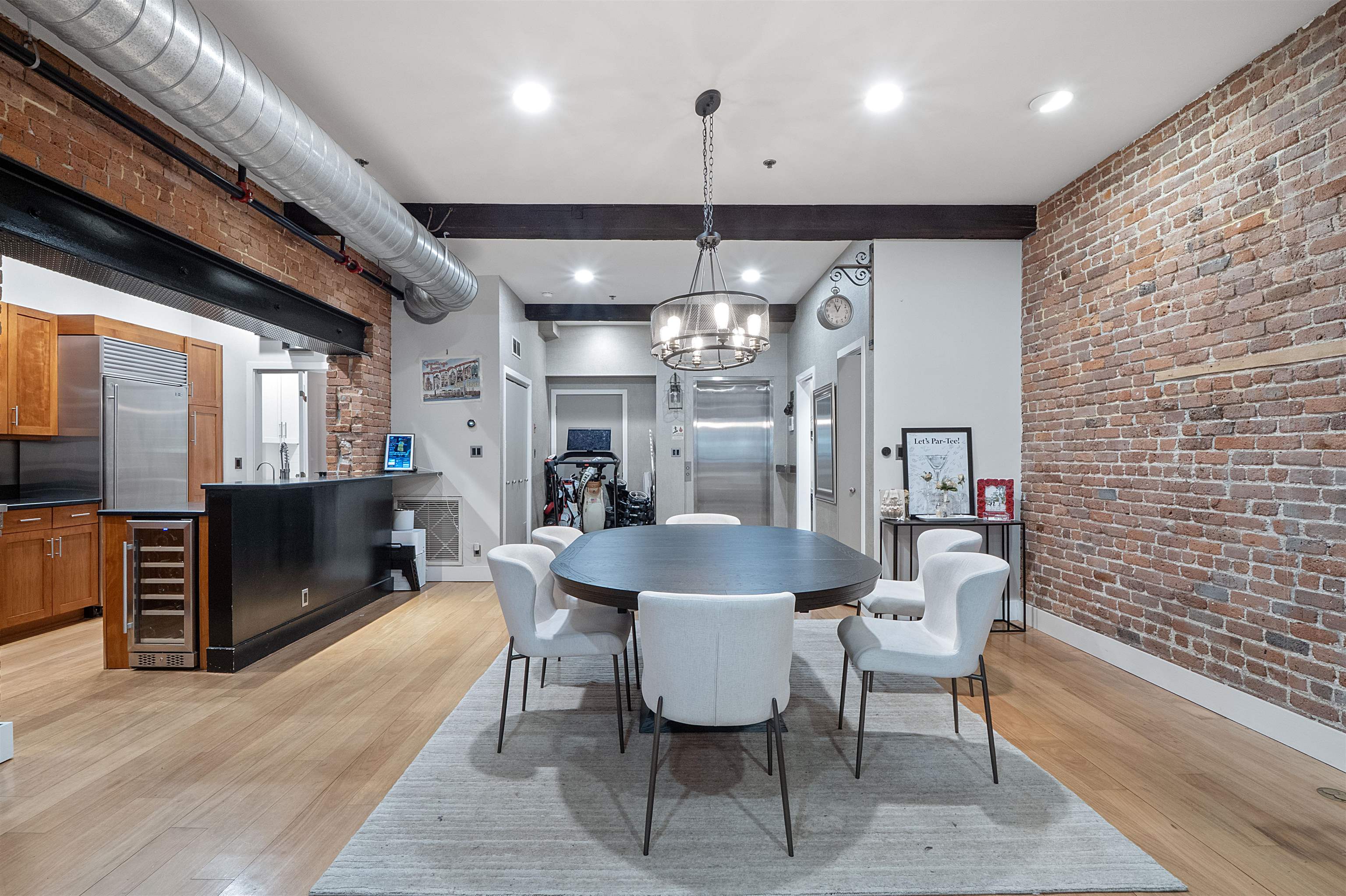 610 Clinton Street, Unit 2A Hoboken, NJ 07030 - Photo 8 of 33 a dining room with furniture and a chandelier