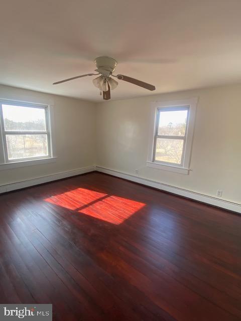 20773 Atlanta Road, Unit 87 Seaford, DE 19973 - Photo 14 of 20 an empty room with wooden floor fan and windows