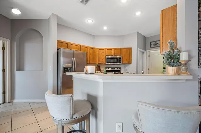a kitchen with stainless steel appliances a refrigerator and a stove top oven
