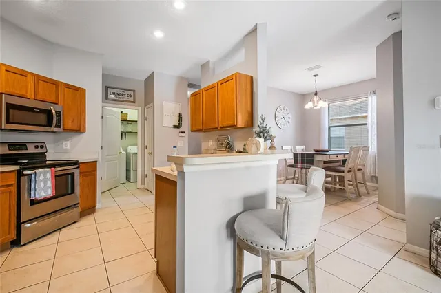 a kitchen with stainless steel appliances kitchen island granite countertop a sink and cabinets