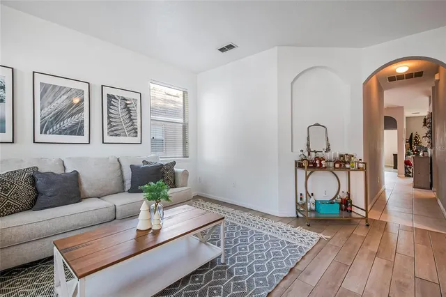 a living room with furniture a rug and a table