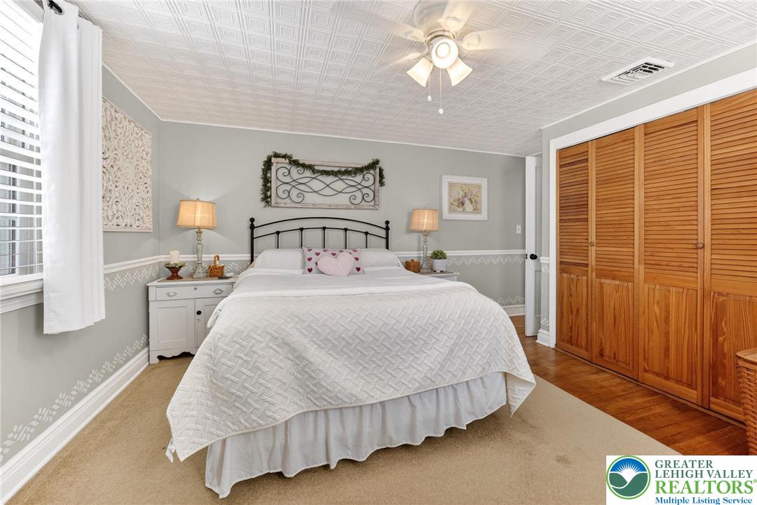 926 Buttonwood Street Emmaus, PA 18049 - Photo 20 of 63 a bedroom with a bed and a chandelier