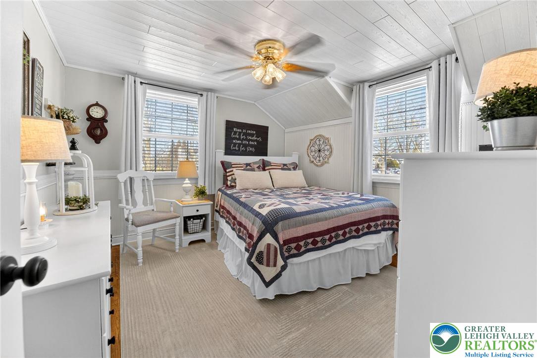 926 Buttonwood Street Emmaus, PA 18049 - Photo 23 of 63 a bedroom with a bed and a chandelier
