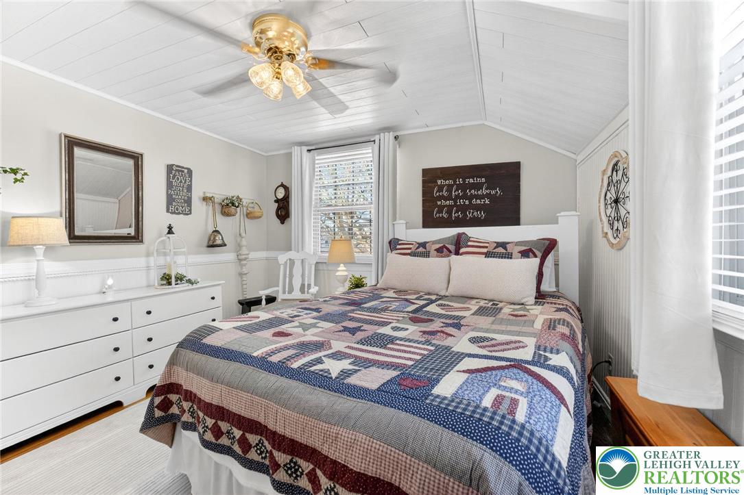 926 Buttonwood Street Emmaus, PA 18049 - Photo 25 of 63 a bedroom with a bed and a chandelier