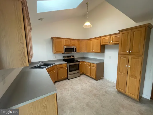 a kitchen with a refrigerator and a sink