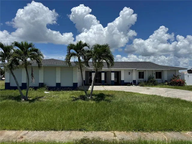 a front view of house with a garden