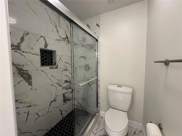 a white toilet sitting next to a bathroom sink