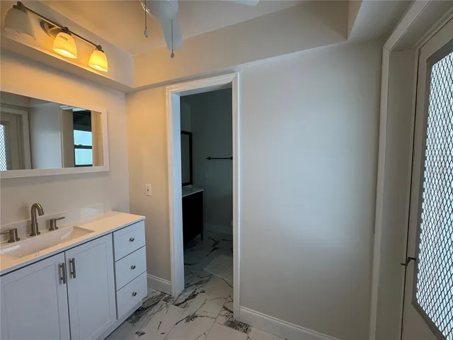 a en suite bathroom with a sink a mirror and a shower