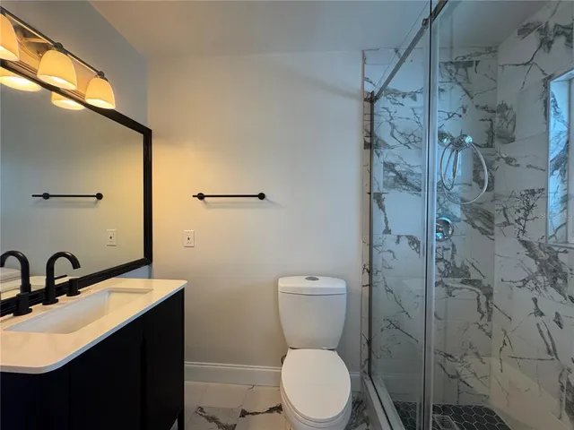 a bathroom with a sink toilet and shower