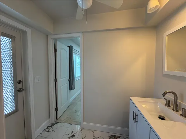 a bathroom with a sink and mirror