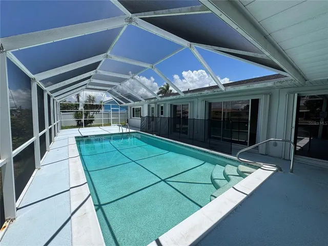 a view of a backyard with table and chairs