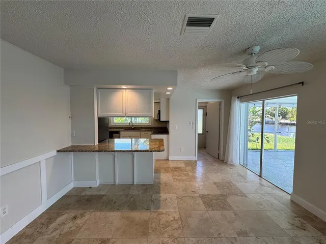 a view of kitchen with refrigerator and window