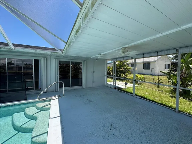 a view of a porch with furniture and a yard