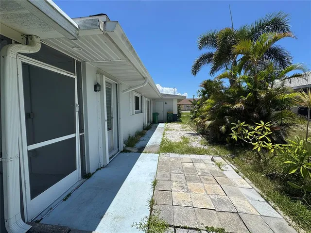a view of a pathway both side of a house