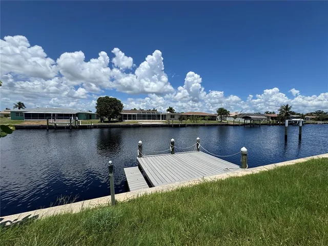 a view of a lake with houses in the back
