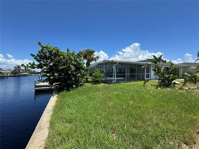 a view of a house with a yard balcony and sitting area