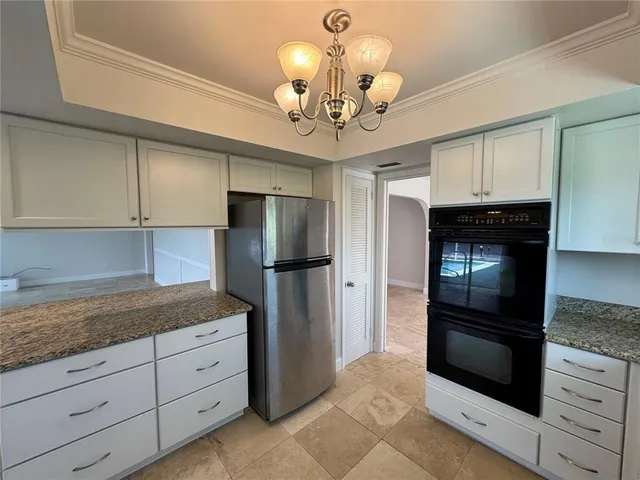 a kitchen with a refrigerator and microwave