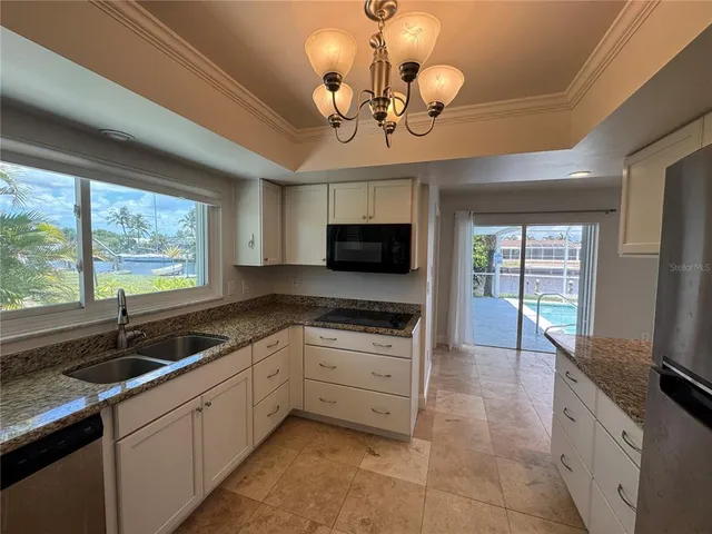 a kitchen with stainless steel appliances granite countertop a sink and stove