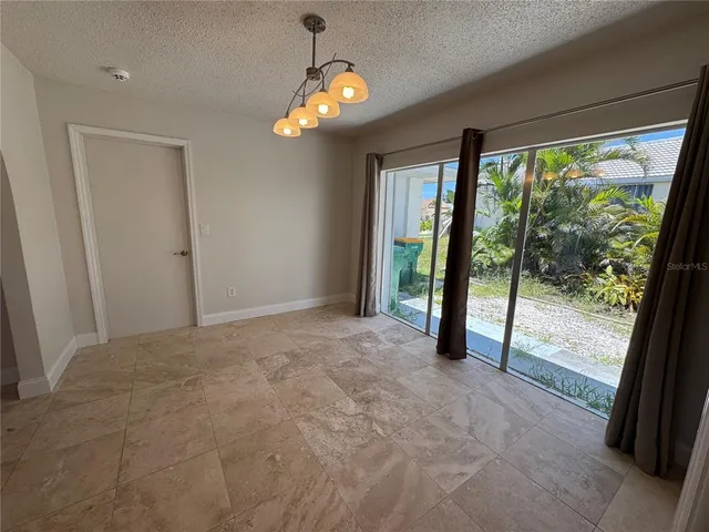 a view of an empty room with a fireplace and a large window