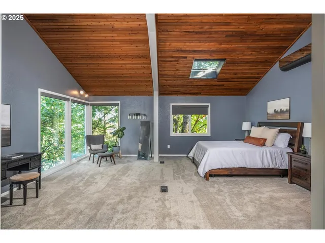 a bed room with a bed and a chair