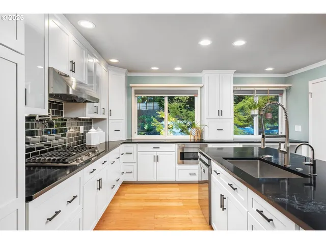 a kitchen with a sink stove top oven and refrigerator