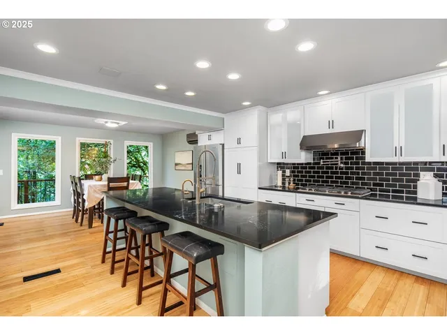 a kitchen with stainless steel appliances kitchen island granite countertop a sink and cabinets