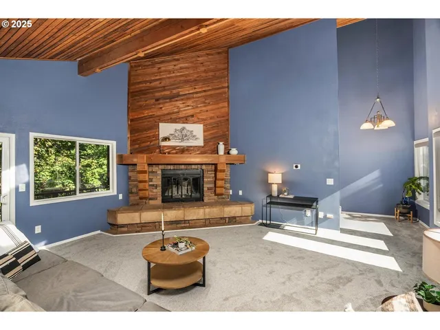 a living room with furniture a window and a fireplace
