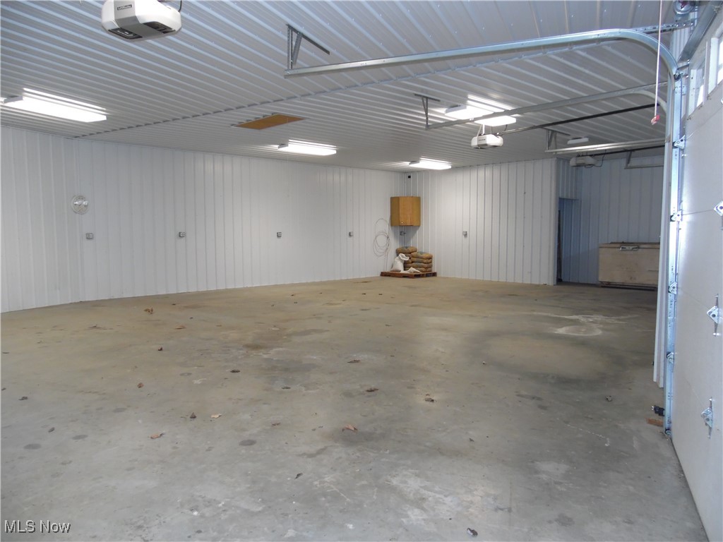 2800 Tick Ridge Road Lower Salem, OH 45745 - Photo 9 of 28 Garage featuring metal wall and a garage door opener