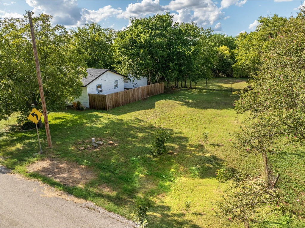 a backyard of a house with a yard and outdoor seating
