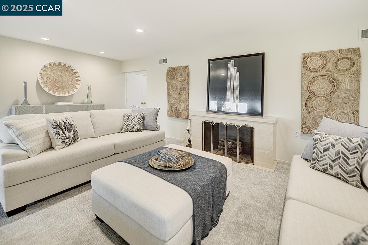 2900 Tice Creek Drive, Unit 1 & 3 Walnut Creek, CA 94595 - Photo 26 of 58 a living room with furniture a fireplace and wall paintings