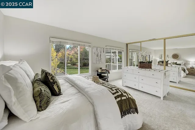 a living room with furniture and a large mirror