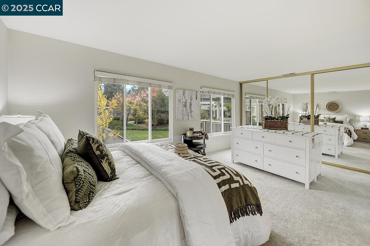 2900 Tice Creek Drive, Unit 1 & 3 Walnut Creek, CA 94595 - Photo 29 of 58 a bedroom with a bed and large windows