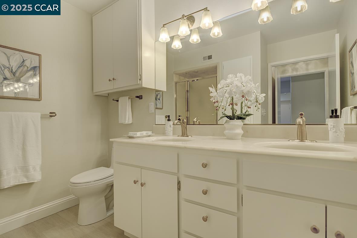 2900 Tice Creek Drive, Unit 1 & 3 Walnut Creek, CA 94595 - Photo 35 of 58 a bathroom with a toilet sink and mirror